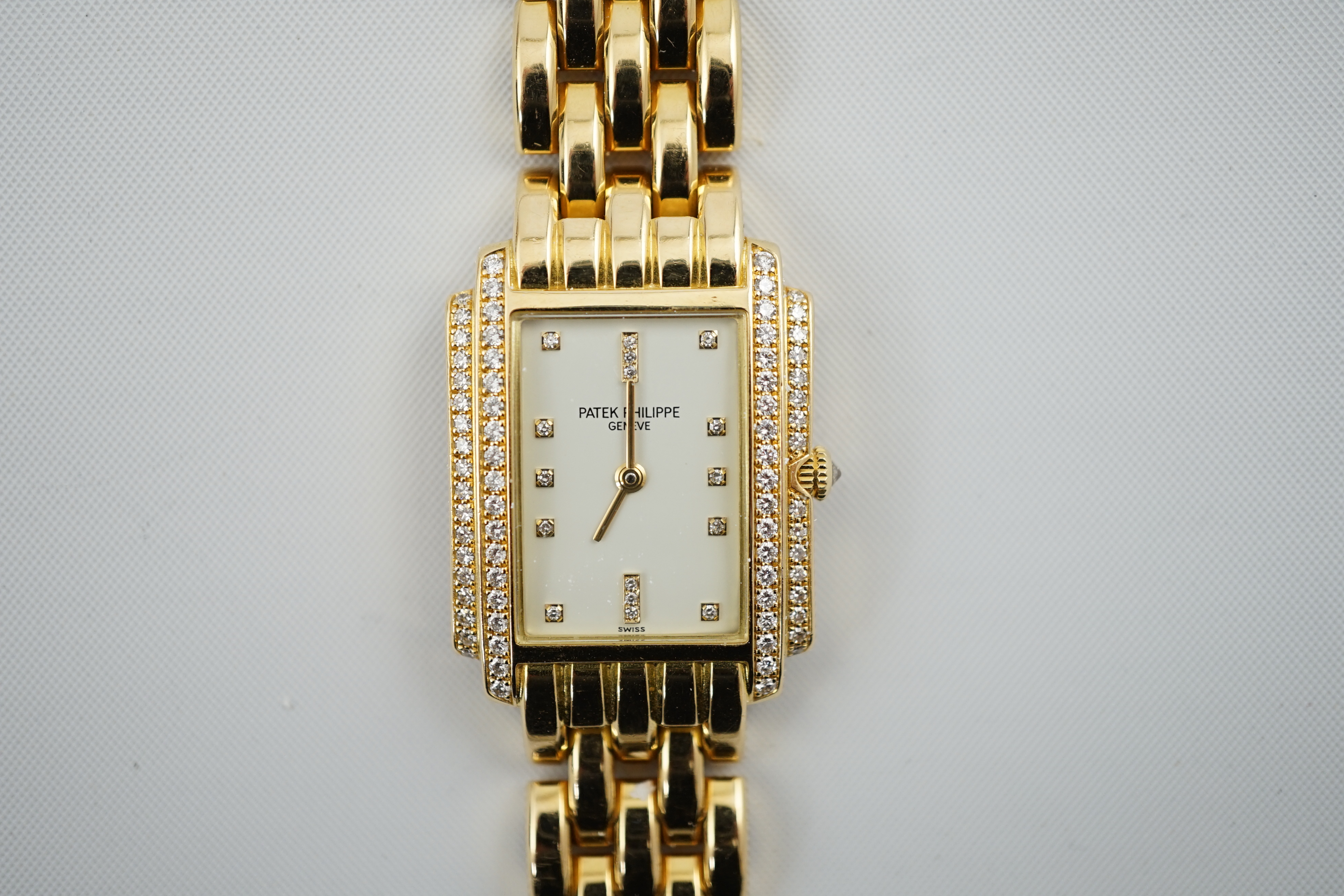 A lady's late 1990's 18ct gold and diamond set Patek Philippe Gondolo quartz wrist watch, on an 18ct gold Patek Philippe bracelet